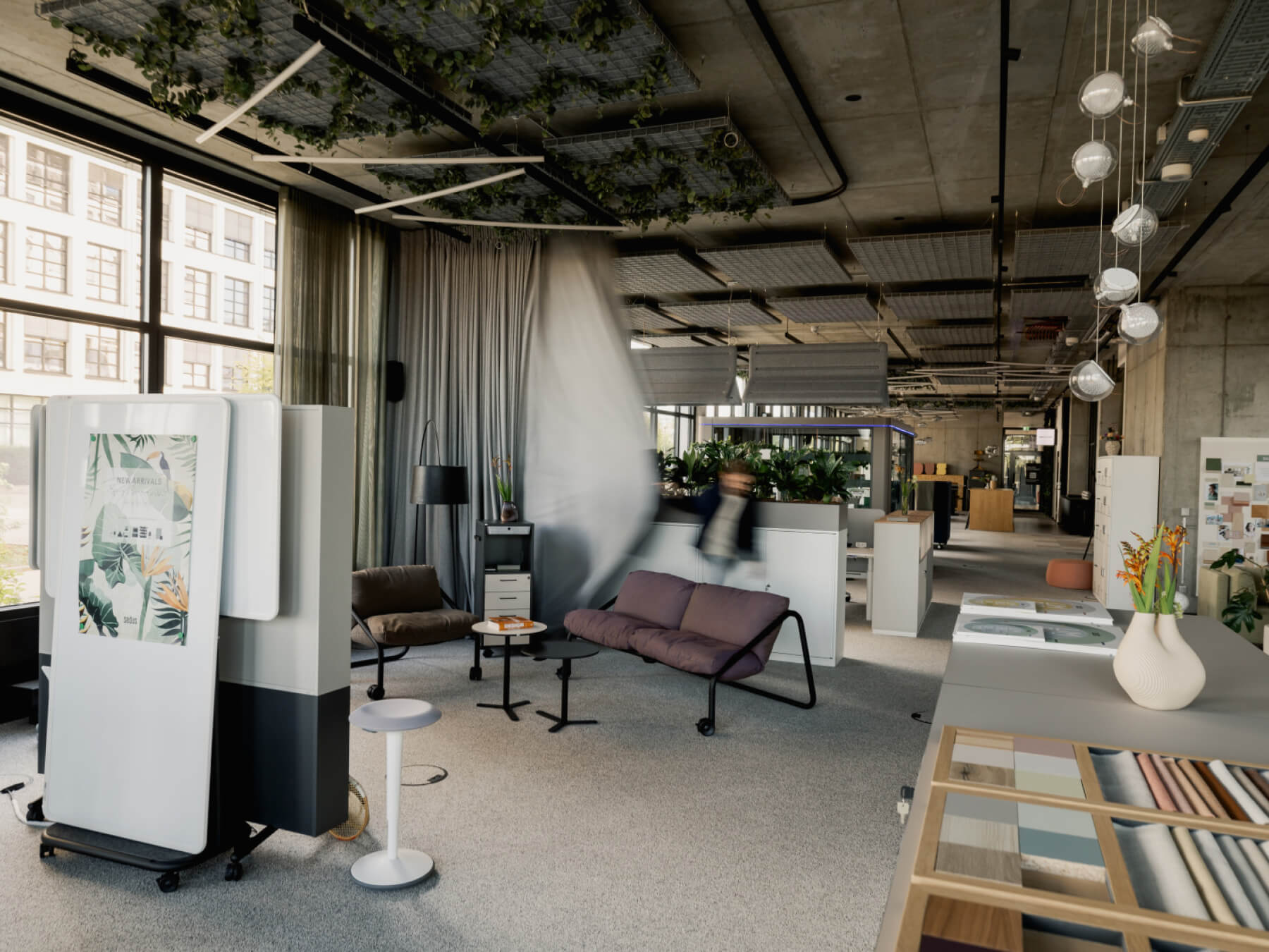 Open-plan industrial-style office with organic elements.