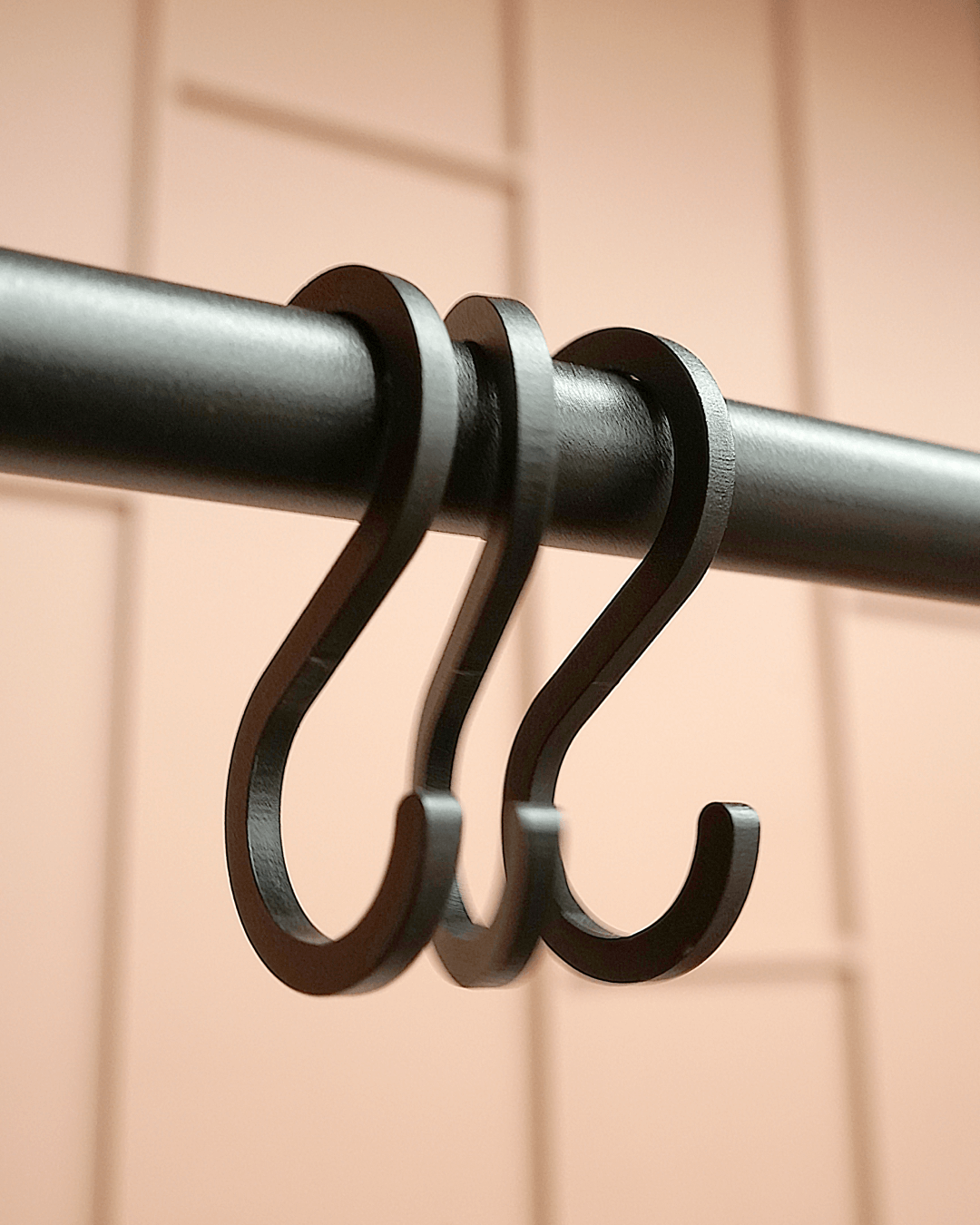 Black S-hook on the hanger tube for Clothing house.